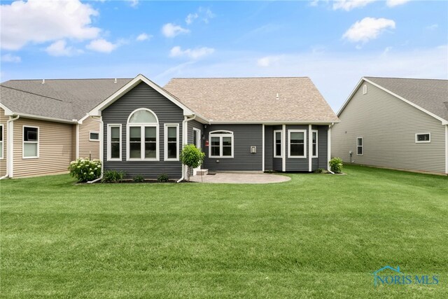 4825 Sylvan Prairie Ct, Sylvania, OH 43560 - back of property featuring a patio, a lawn, and roof with shingles