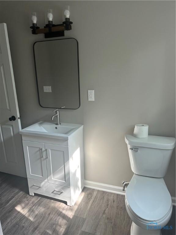 101 S Madison St, Antwerp, OH 45813 - half bath featuring wood finished floors and vanity