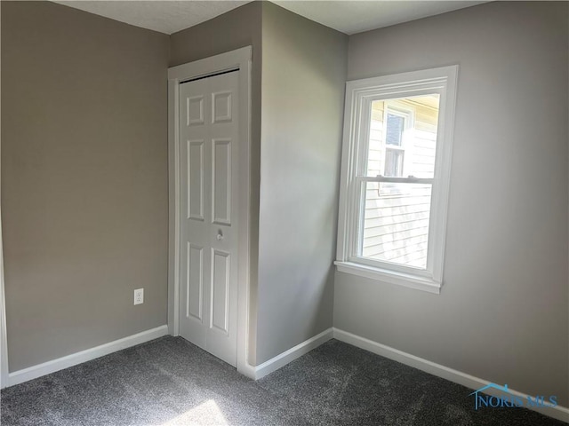 101 S Madison St, Antwerp, OH 45813 - unfurnished bedroom with dark carpet and baseboards