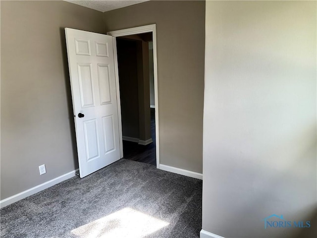 101 S Madison St, Antwerp, OH 45813 - unfurnished room featuring dark carpet and baseboards