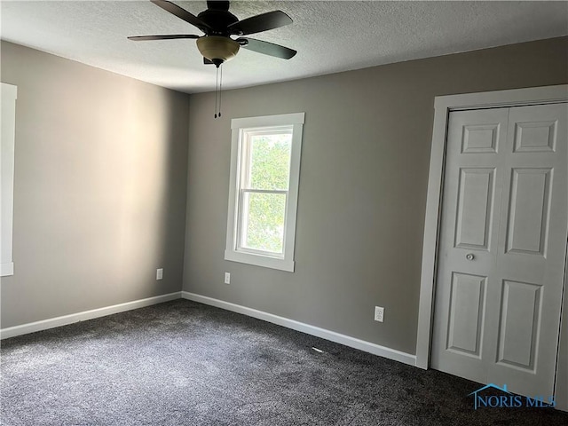 101 S Madison St, Antwerp, OH 45813 - spare room with ceiling fan, a textured ceiling, and dark colored carpet