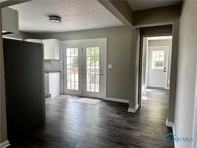 101 S Madison St, Antwerp, OH 45813 - unfurnished dining area with plenty of natural light, dark wood-style floors, and a textured ceiling
