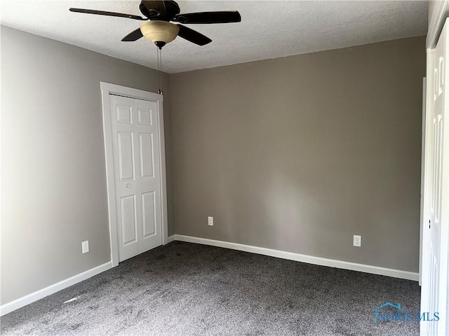 101 S Madison St, Antwerp, OH 45813 - unfurnished bedroom featuring dark colored carpet, a textured ceiling, and a ceiling fan