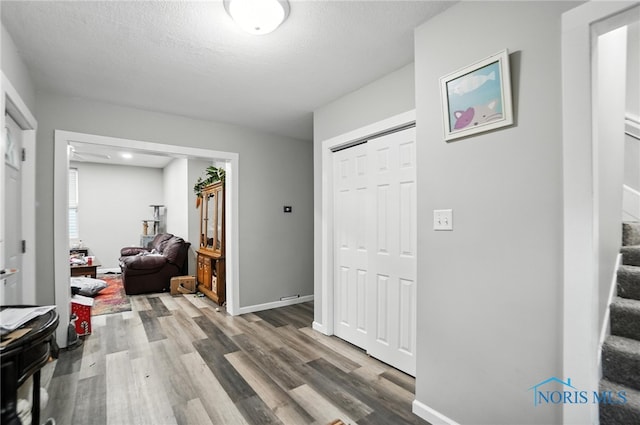 407 Washington St, Findlay, OH 45840 - foyer entrance with wood finished floors, stairway, and a textured ceiling