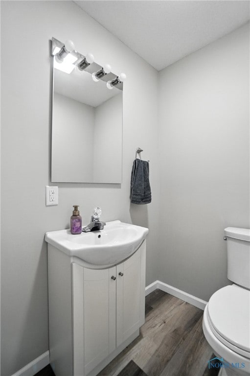 407 Washington St, Findlay, OH 45840 - half bathroom with vanity and wood finished floors