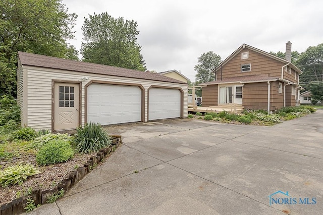 5712 Rambo Ln, Toledo, OH 43623 - view of front of home featuring an outdoor structure, a garage, and a chimney