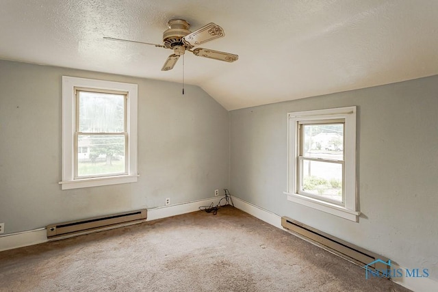 5712 Rambo Ln, Toledo, OH 43623 - additional living space featuring baseboard heating, ceiling fan, vaulted ceiling, carpet floors, and a textured ceiling