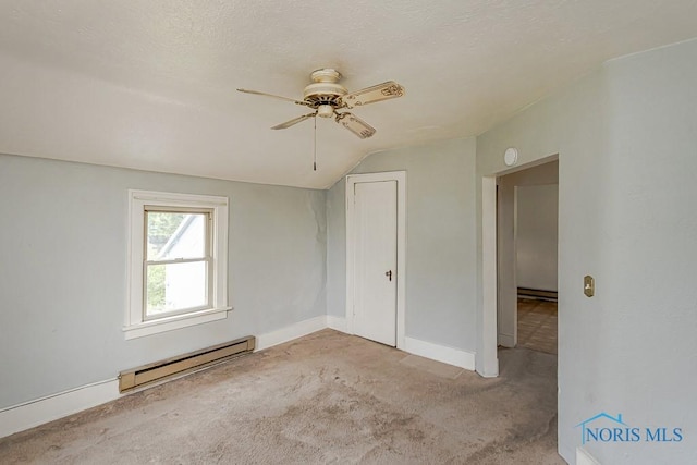 5712 Rambo Ln, Toledo, OH 43623 - carpeted spare room featuring a baseboard heating unit, a ceiling fan, and vaulted ceiling
