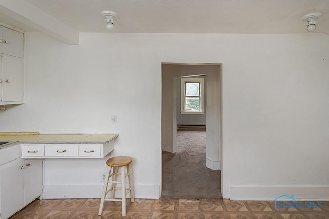 5712 Rambo Ln, Toledo, OH 43623 - kitchen featuring light countertops, white cabinets, and baseboard heating