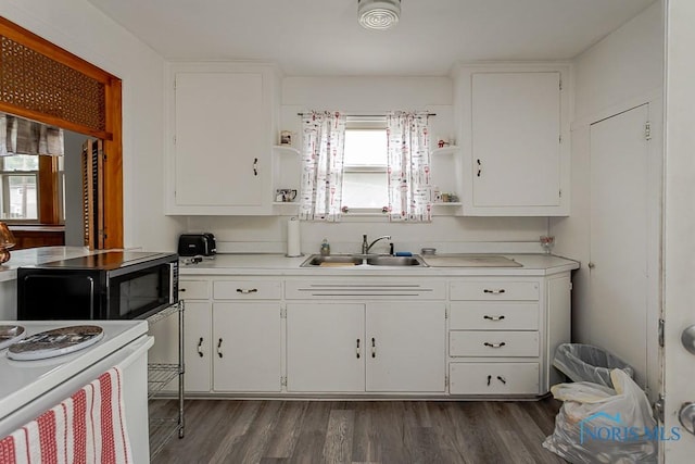 5712 Rambo Ln, Toledo, OH 43623 - kitchen with open shelves, black microwave, light countertops, and white cabinets