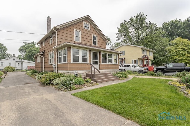 5712 Rambo Ln, Toledo, OH 43623 - view of front of property featuring a chimney and a front lawn