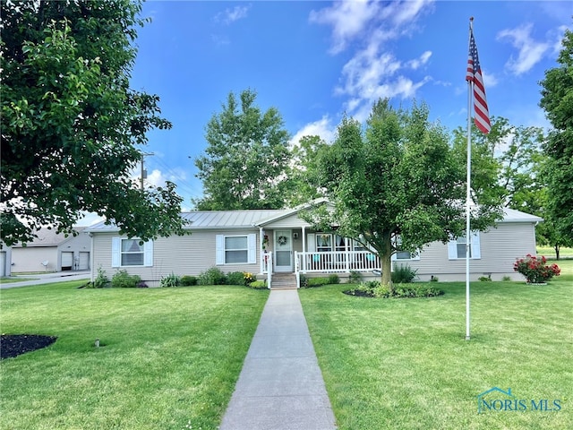 120 E Nicholas St, Arlington, OH 45814 - view of front of house with covered porch, a front yard, and a metal roof
