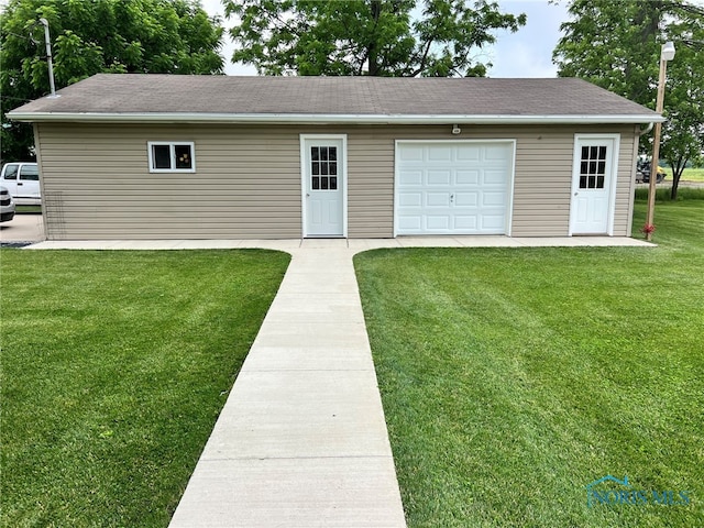 120 E Nicholas St, Arlington, OH 45814 - view of front facade featuring an outbuilding, a front lawn, a garage, and a shingled roof