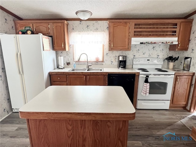 120 E Nicholas St, Arlington, OH 45814 - kitchen featuring white appliances, dark wood-style floors, wallpapered walls, light countertops, and a kitchen island