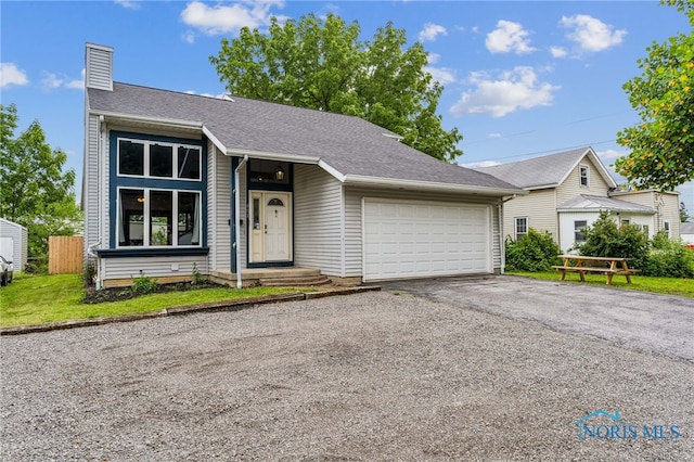 801 W Sandusky St, Findlay, OH 45840 - view of front facade featuring an attached garage, a chimney, asphalt driveway, and roof with shingles