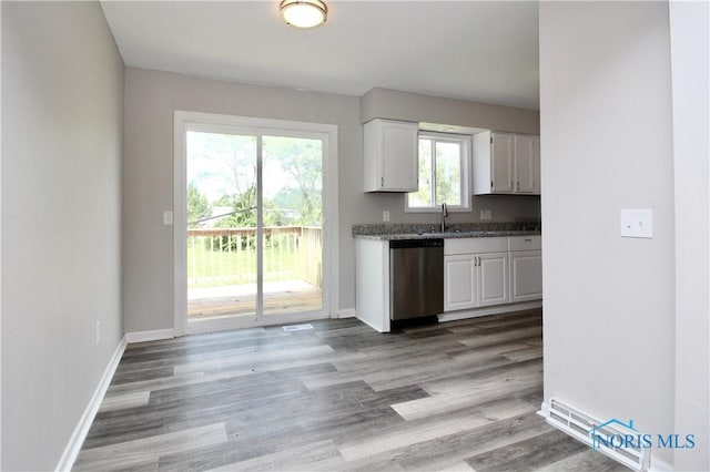 6182 Old Farm Ct, Toledo, OH 43612 - kitchen featuring stainless steel dishwasher, white cabinets, light wood-type flooring, and dark stone counters
