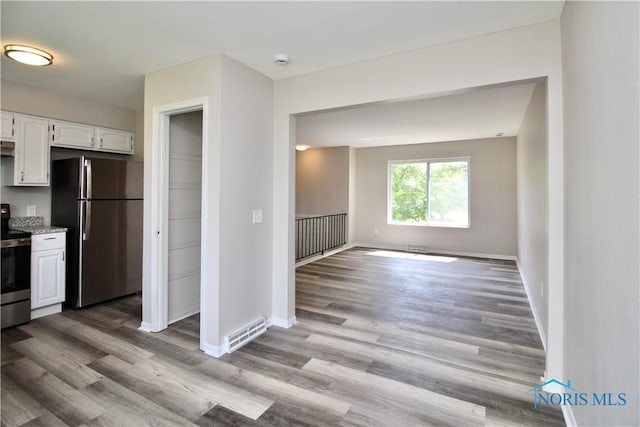 6182 Old Farm Ct, Toledo, OH 43612 - kitchen with appliances with stainless steel finishes, white cabinets, wood finished floors, open floor plan, and light stone countertops