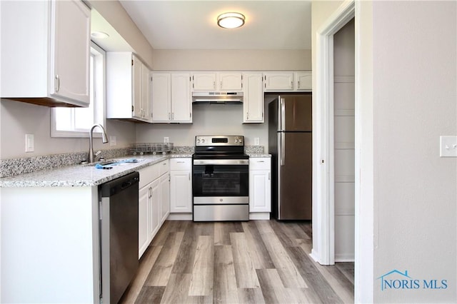 6182 Old Farm Ct, Toledo, OH 43612 - kitchen with stainless steel appliances, under cabinet range hood, white cabinets, and light wood-style floors