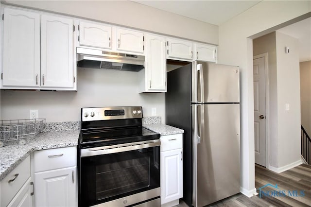 6182 Old Farm Ct, Toledo, OH 43612 - kitchen with stainless steel appliances, under cabinet range hood, white cabinets, and wood finished floors