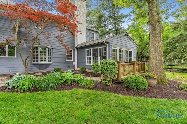 424 Lynshire Ln, Findlay, OH 45840 - back of property with a chimney, a deck, and a yard