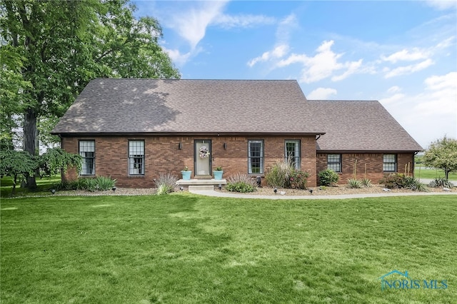 772 Fairway Ln, Wauseon, OH 43567 - view of front of home featuring a shingled roof, brick siding, and a front yard