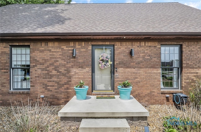 772 Fairway Ln, Wauseon, OH 43567 - doorway to property featuring a shingled roof and brick siding