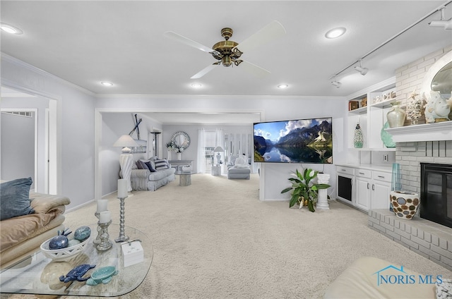 772 Fairway Ln, Wauseon, OH 43567 - living room with light carpet, a fireplace, crown molding, a ceiling fan, and recessed lighting