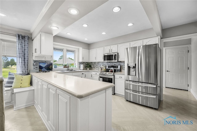 772 Fairway Ln, Wauseon, OH 43567 - kitchen featuring stainless steel appliances, a peninsula, white cabinets, light countertops, and recessed lighting