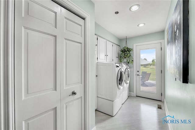 772 Fairway Ln, Wauseon, OH 43567 - laundry room with washer and dryer, cabinet space, light wood-type flooring, and recessed lighting