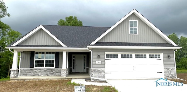 7811 Sonoma Dr, Monclova, OH 43542 - craftsman-style home featuring stone siding, board and batten siding, a porch, and a garage