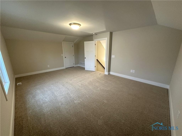 7811 Sonoma Dr, Monclova, OH 43542 - carpeted empty room with vaulted ceiling and baseboards