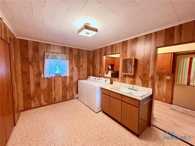 237 Pontious Pl, Napoleon, OH 43545 - washroom with washer and clothes dryer, cabinet space, wooden walls, and crown molding