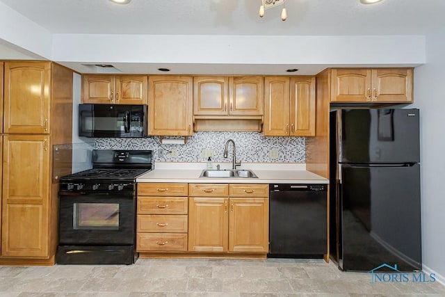 564 Southfield Dr, Maumee, OH 43537 - kitchen featuring black appliances, light countertops, tasteful backsplash, and light stone finish flooring