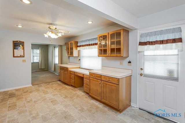 564 Southfield Dr, Maumee, OH 43537 - kitchen featuring brown cabinets, glass insert cabinets, light countertops, a ceiling fan, and recessed lighting