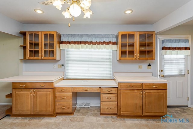 564 Southfield Dr, Maumee, OH 43537 - kitchen with glass insert cabinets, plenty of natural light, and light countertops