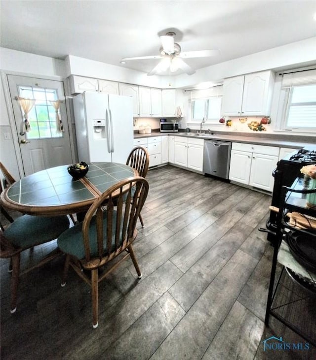328 W Prentiss Ave, Findlay, OH 45840 - kitchen with appliances with stainless steel finishes, white cabinets, a ceiling fan, and dark wood-style floors