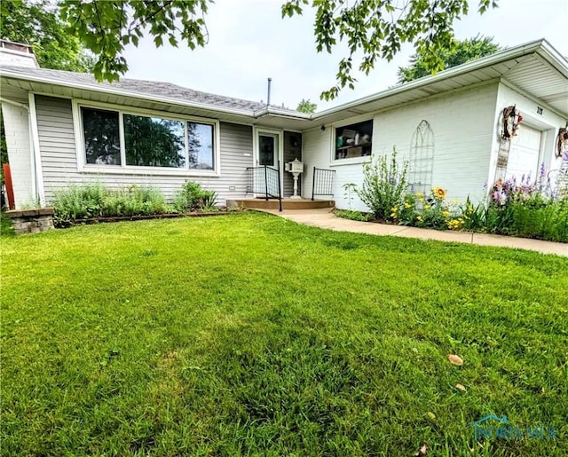 328 W Prentiss Ave, Findlay, OH 45840 - ranch-style house with a front yard, an attached garage, and a chimney
