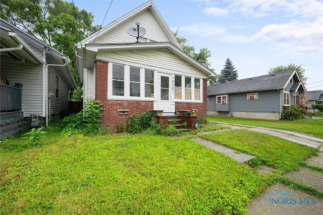 1930 Berkshire Pl, Toledo, OH 43613 - view of front of house with brick siding and a front lawn