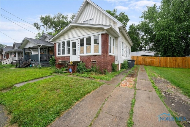1930 Berkshire Pl, Toledo, OH 43613 - bungalow-style home featuring brick siding, a porch, and driveway