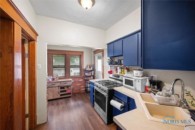 1930 Berkshire Pl, Toledo, OH 43613 - kitchen with gas stove, blue cabinetry, white microwave, and light countertops