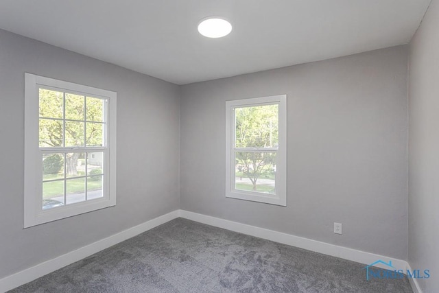2242 Vaness Dr, Toledo, OH 43615 - empty room featuring healthy amount of natural light and dark carpet