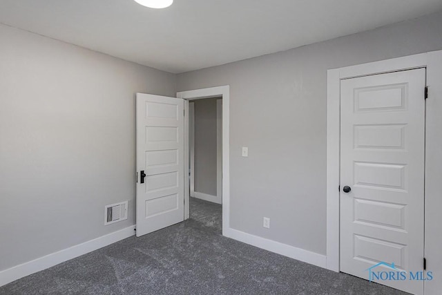 2242 Vaness Dr, Toledo, OH 43615 - unfurnished bedroom featuring dark carpet and baseboards
