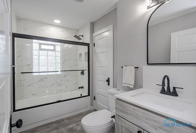 2242 Vaness Dr, Toledo, OH 43615 - bathroom featuring vanity, shower / bath combination with glass door, and wood finished floors