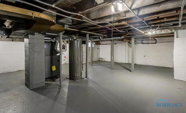 2242 Vaness Dr, Toledo, OH 43615 - unfinished below grade area with water heater, heating unit, and concrete block wall