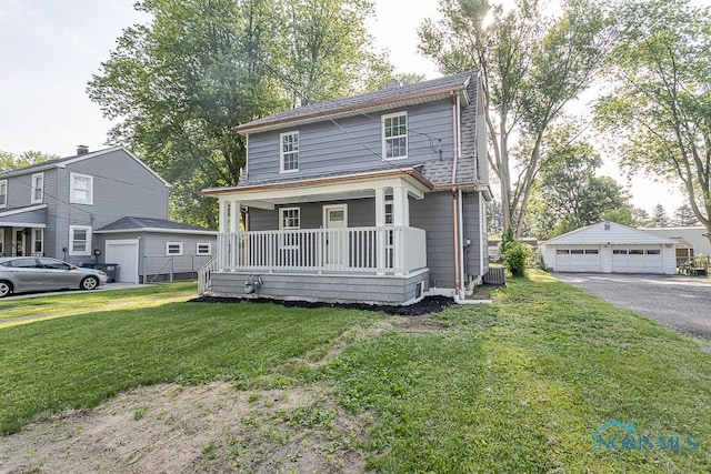 2242 Vaness Dr, Toledo, OH 43615 - american foursquare style home featuring covered porch, a garage, a front lawn, and an outbuilding
