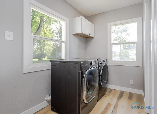 2242 Vaness Dr, Toledo, OH 43615 - laundry room featuring cabinet space, washing machine and dryer, and light wood-style flooring