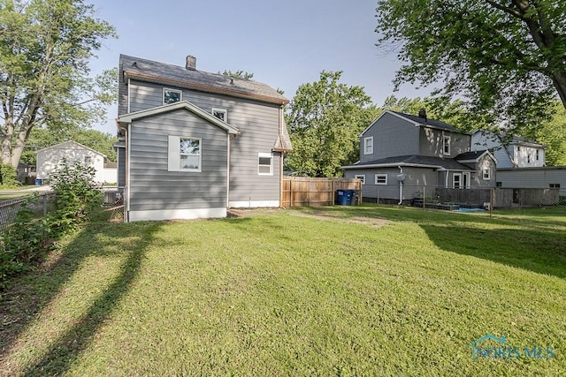2242 Vaness Dr, Toledo, OH 43615 - back of property featuring a fenced backyard and a chimney