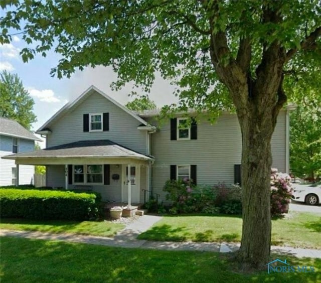 404 E Garfield Ave, Swanton, OH 43558 - view of front facade featuring a front yard