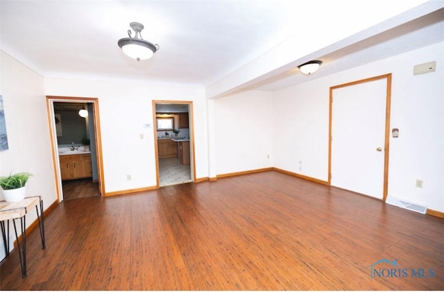 404 E Garfield Ave, Swanton, OH 43558 - empty room with wood finished floors and baseboards