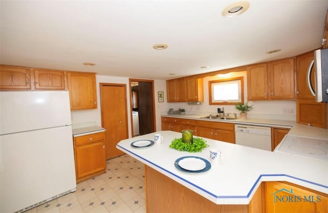 404 E Garfield Ave, Swanton, OH 43558 - kitchen featuring white appliances, light countertops, light flooring, a peninsula, and recessed lighting